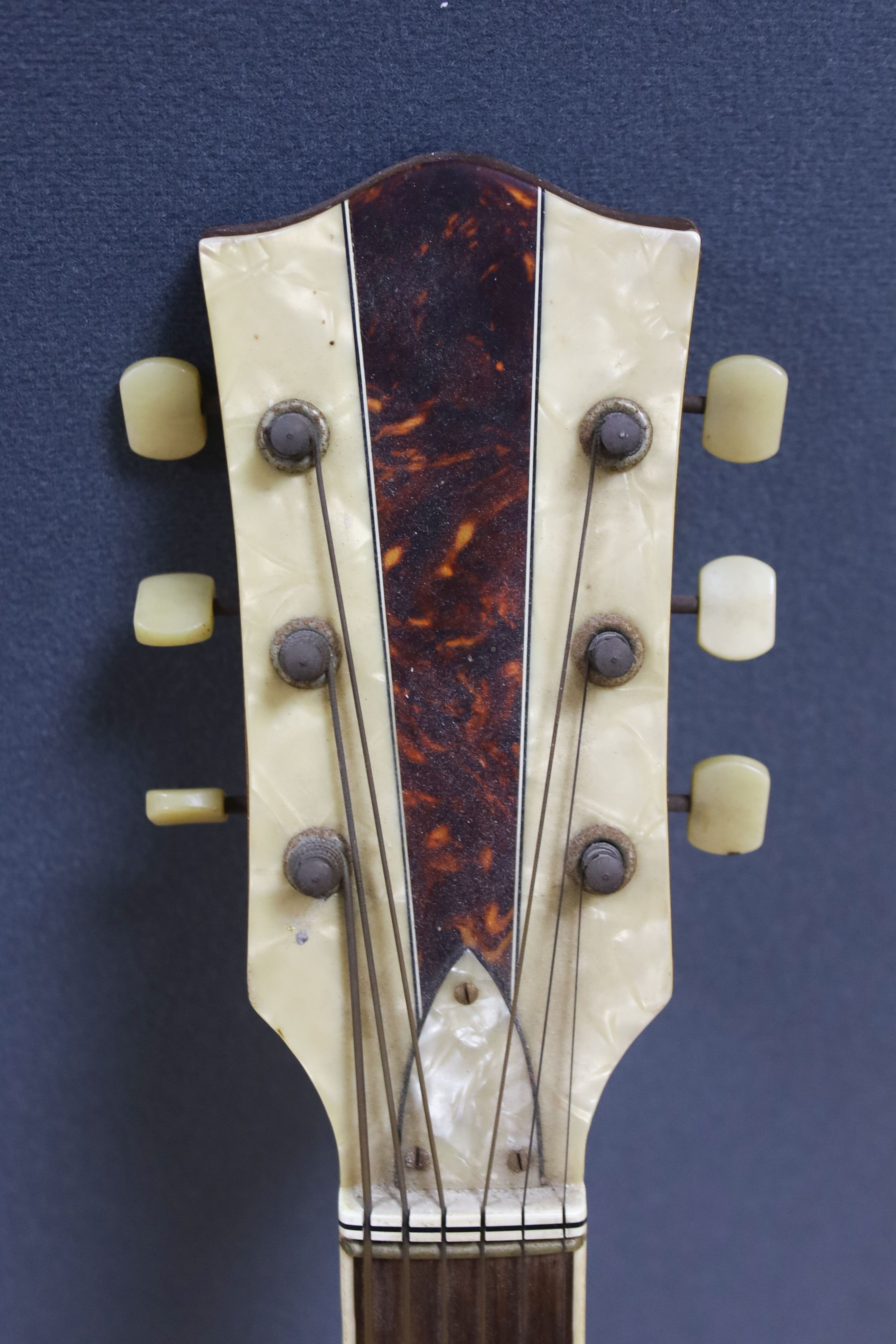 A Hofner acoustic f-hole guitar, circa 1950, having mother of pearl and tortoiseshell inlay to fret and head